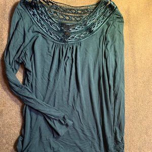 Boat-neck blue top with fun design around opening